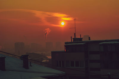 Buildings against sky during sunset