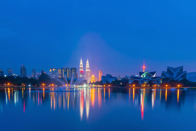 Illuminated city buildings at waterfront