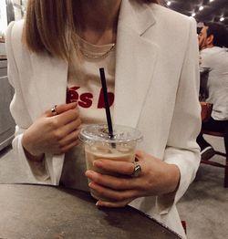 Midsection of woman drinking glass