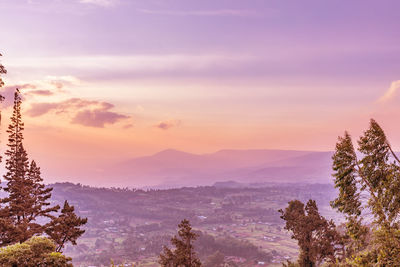 Scenic view of mountains against sky at sunset