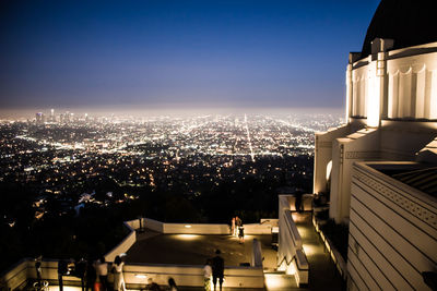 High angle view of illuminated buildings in city at night