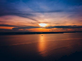 Scenic view of sea against romantic sky at sunset