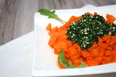 Close-up of chopped fruits in plate on table