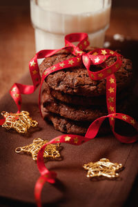 High angle view of tied up cookies by christmas ornaments at table