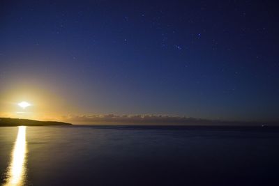 Scenic view of sea against sky at night