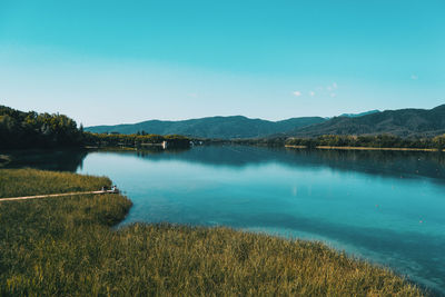 Scenic view of lake against blue sky