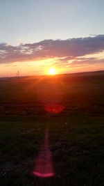 Scenic view of field against sky during sunset