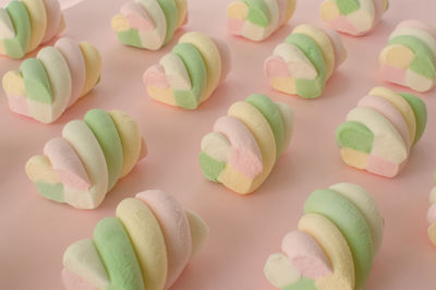 Colorful marshmallows composition on a pink background - copy space - children candies concept