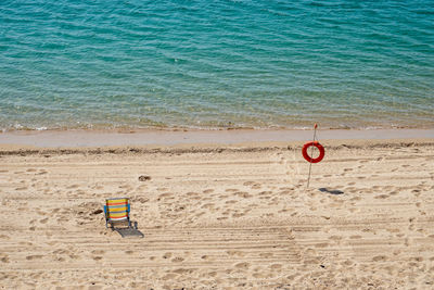 High angle view of sunglasses on beach