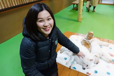 Portrait of smiling woman petting dogs