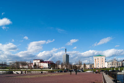 Buildings in city against blue sky