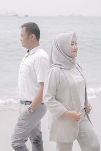 Friends standing on beach
