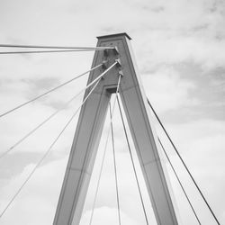 Low angle view of suspension bridge against sky