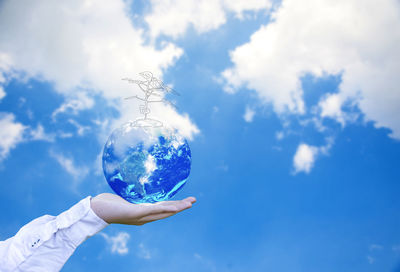 Low angle view of hand against sky