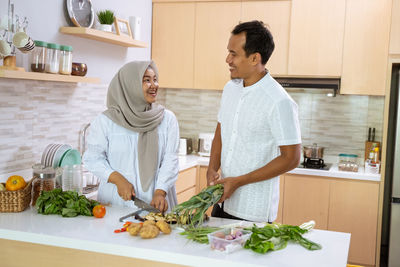 Young man preparing food on table at home