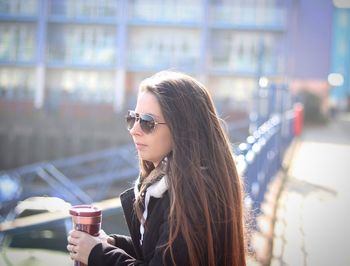 Young woman drinking coffee outdoors