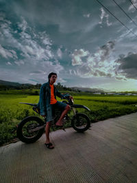 Full length portrait of man riding bicycle against sky