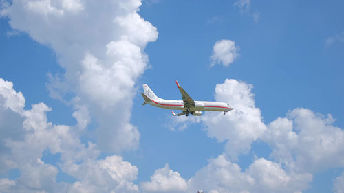 Low angle view of airplane flying against sky