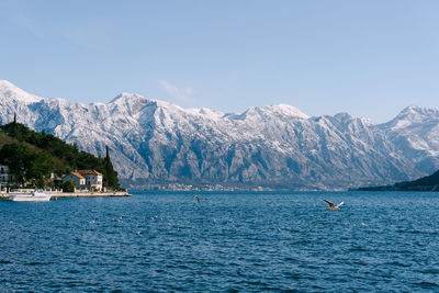 Scenic view of sea and mountains against sky