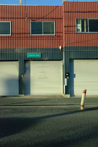 Empty road by building in city