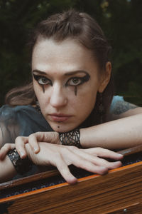 Close up staring woman with druid makeup portrait picture