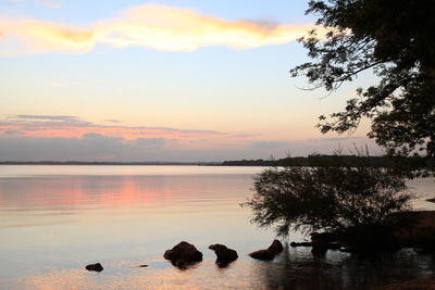 Scenic view of lake at sunset