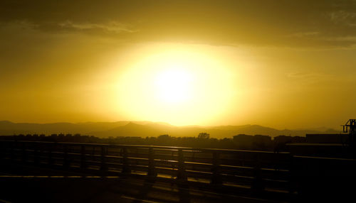 Scenic view of silhouette mountains against sky during sunset