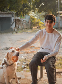 Portrait of young man with dog