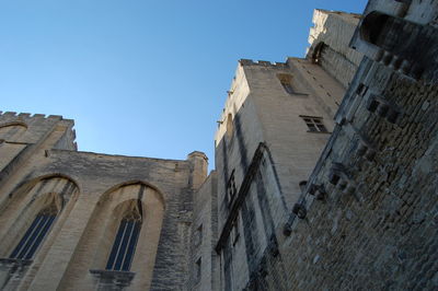 Low angle view of historic building against blue sky