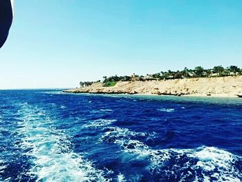 Scenic view of sea against clear blue sky