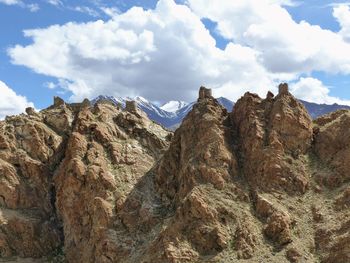 Scenic view of mountains against cloudy sky