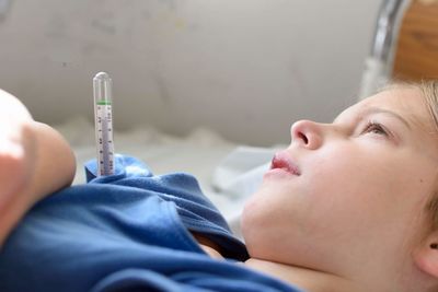 Close-up of child lying on bed