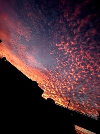 Low angle view of building against sky at sunset