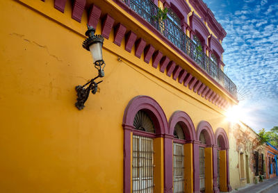 Low angle view of yellow building against sky