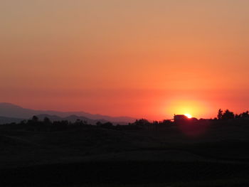 Scenic view of silhouette landscape against sky during sunset