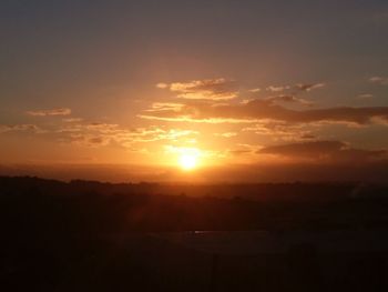 Scenic view of silhouette mountains against sky during sunset