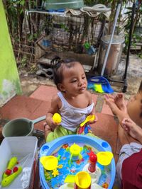 Cute girl sitting in toy car