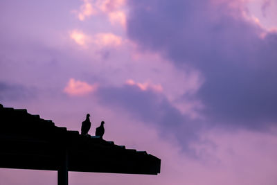 Low angle view of building against sky during sunset