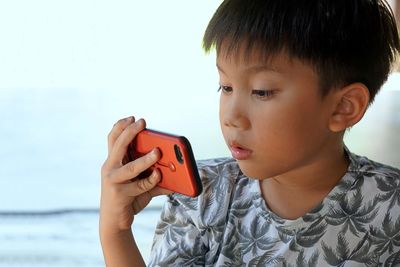 Portrait of boy holding mobile phone