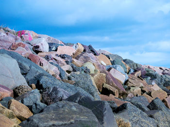 Close-up of rocks on beach against sky