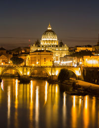 Illuminated buildings against sky at night