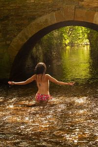 Rear view of woman in lake