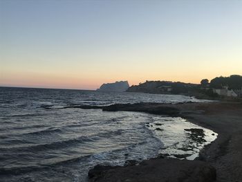 Scenic view of sea against clear sky during sunset