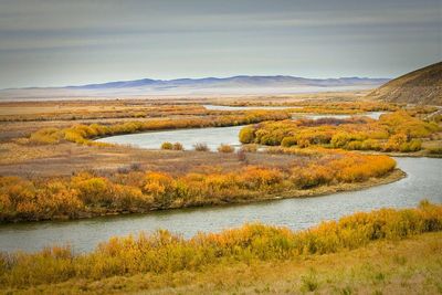 Scenic view of river during autumn against sky