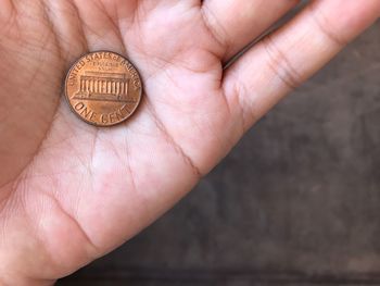 Close-up of person holding coin