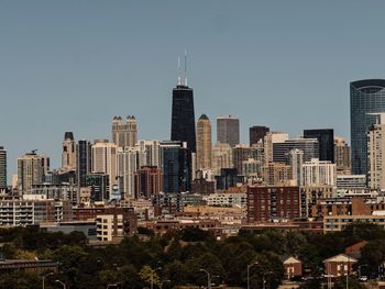 View of buildings in city against clear sky