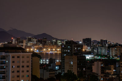 High angle view of illuminated buildings against sky at night