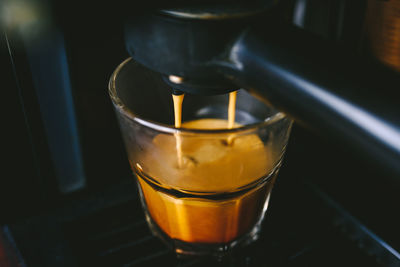 Close-up of tea pouring in glass