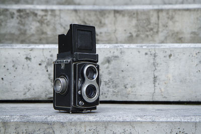 Old-fashioned camera on steps