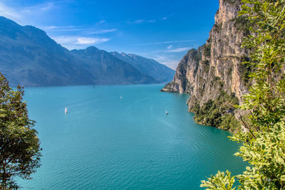 Scenic view of sea and mountains against sky